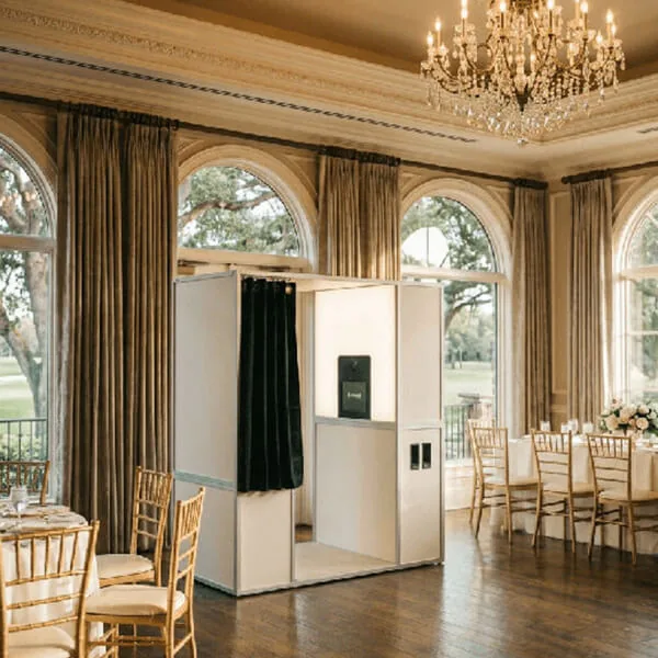 White enclosed Classic Sit-In Photo Booth set up in an elegant Orlando wedding ballroom